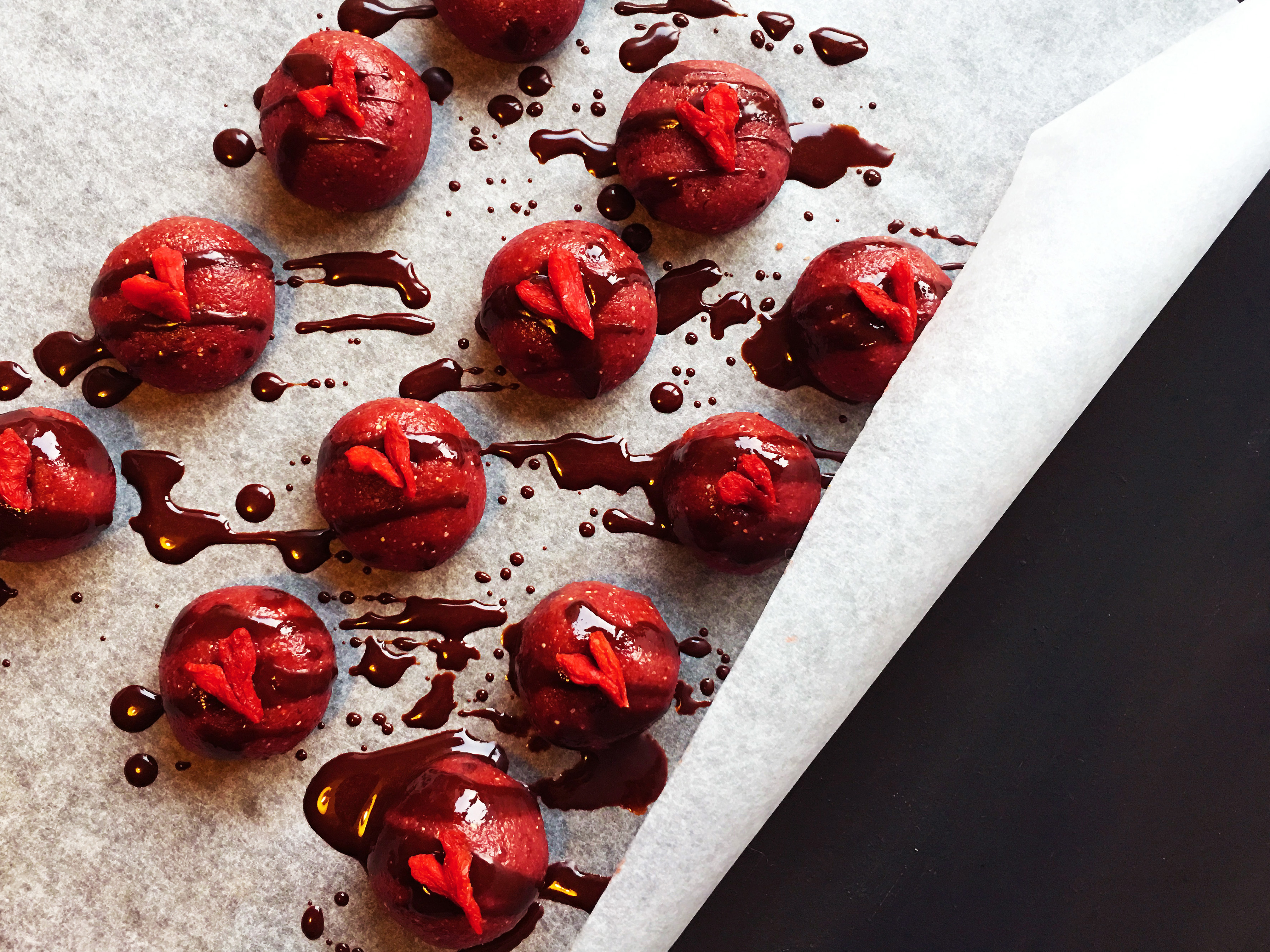 Strawberries and cream Paleo power balls drizzled with chocolate